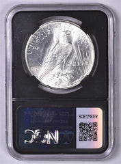 1927-D Peace Silver Dollar - NGC Brilliant UNC Original Relic Bag Label Series